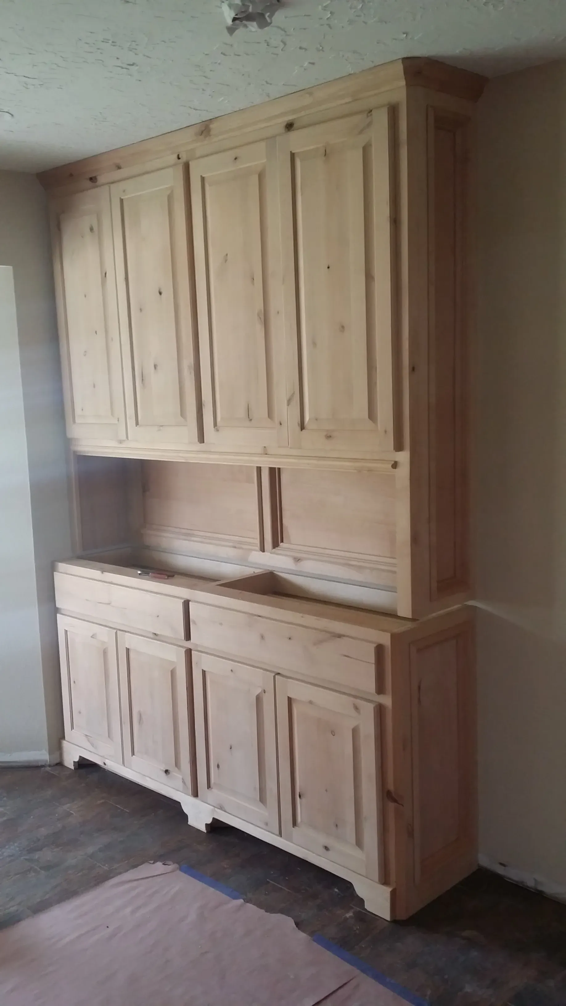 Mudroom built-in with coat hooks, upper cubbies, and bench seat storage