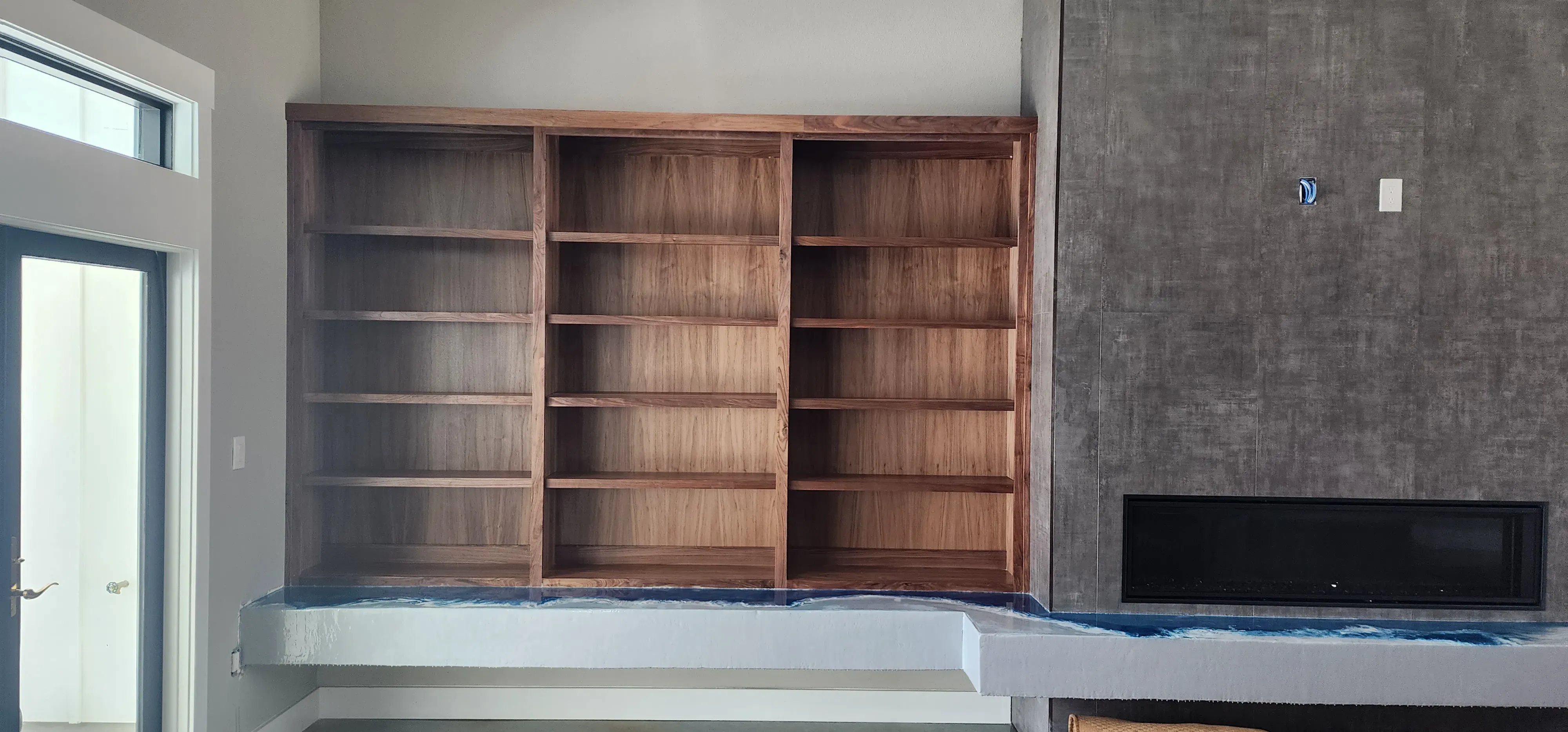 Custom garage workshop storage wall with tool pegboard and pull-out drawer base