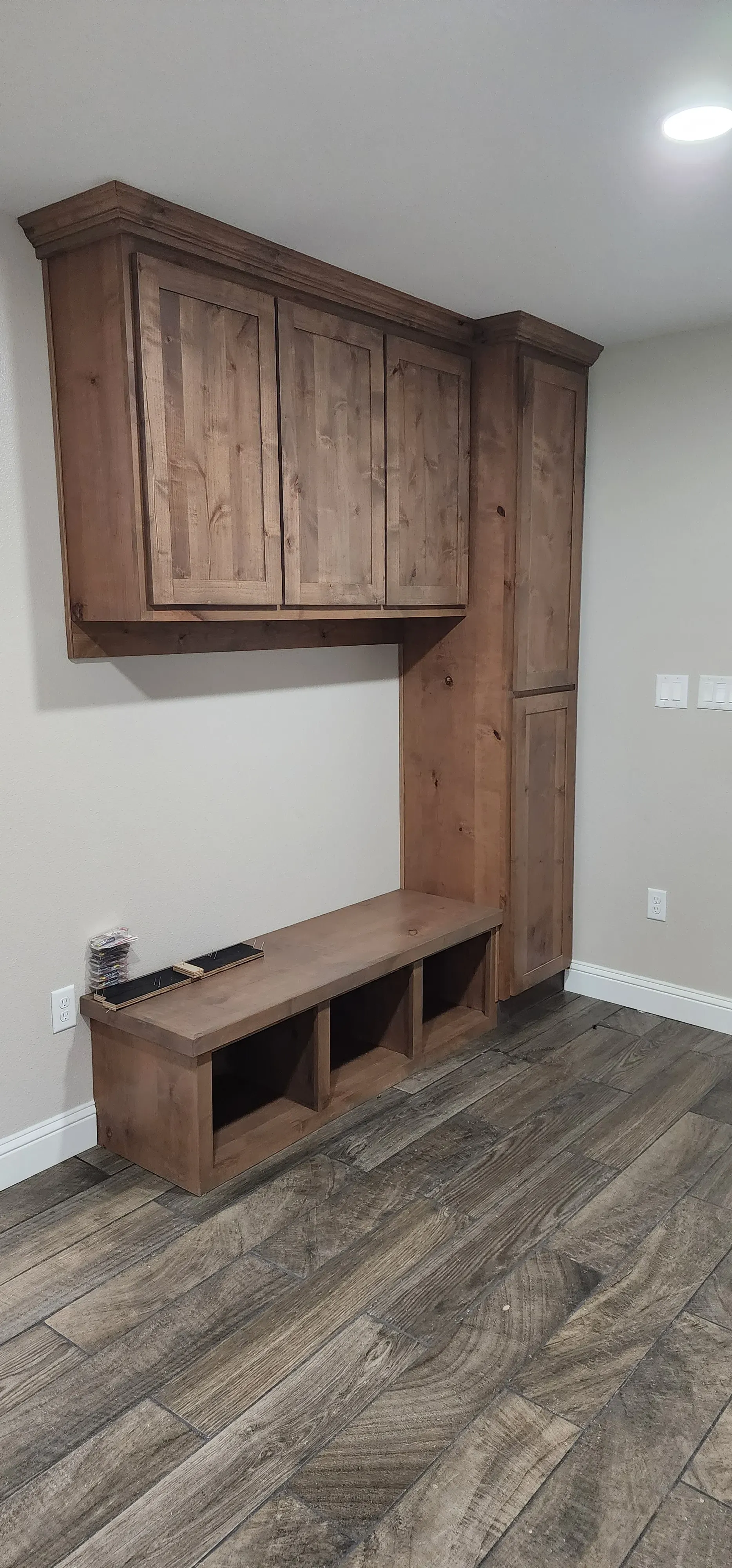 Nursery built-in with changing table surface, open cubbies, and lower toy bins