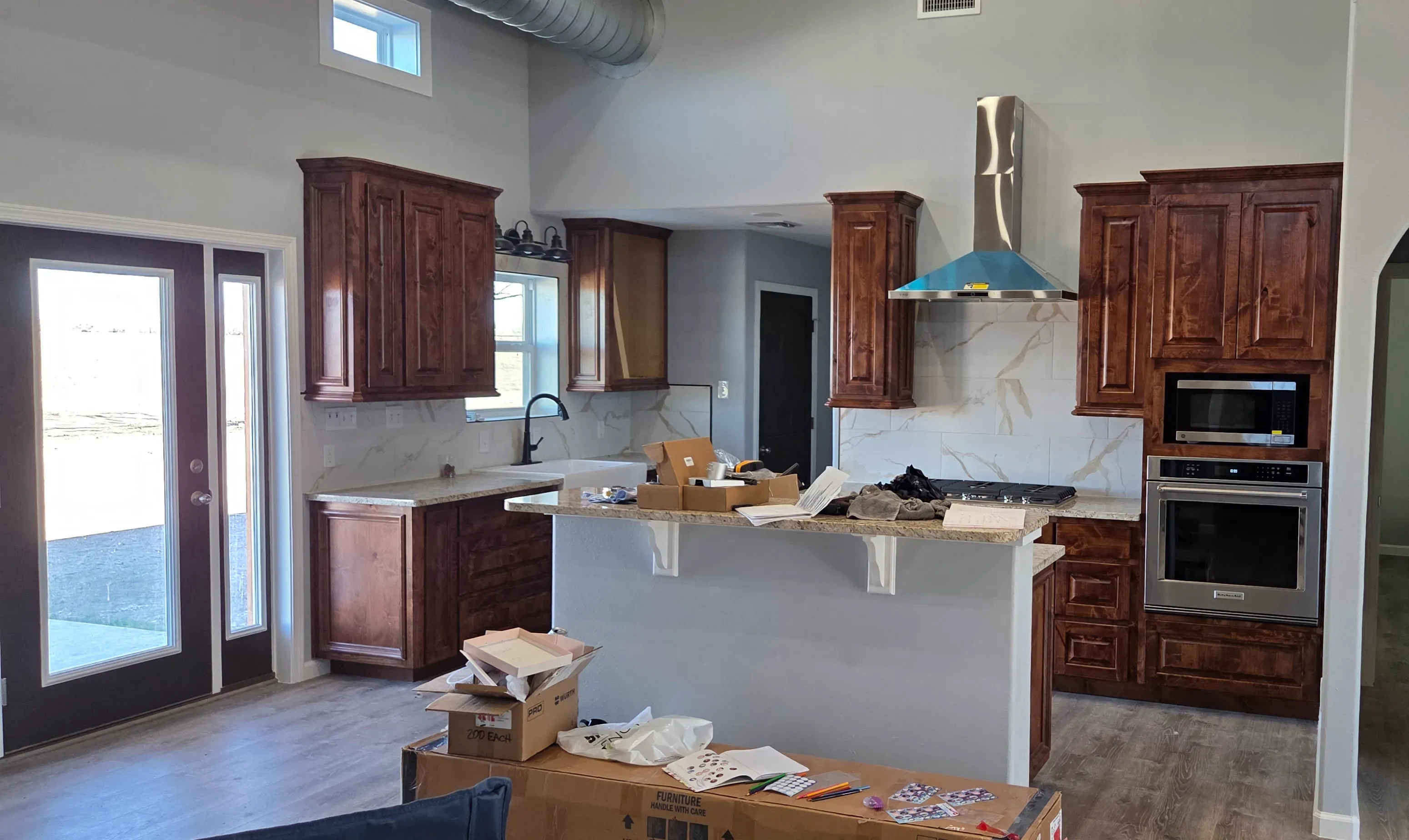 Modern flat-panel kitchen cabinets in a two-tone white and natural wood finish