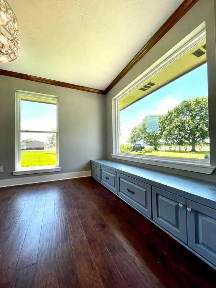 Bathroom vanity built-in with dual sinks, marble countertop, and soft-close cabinetry