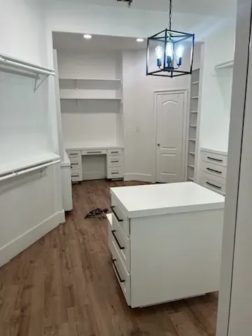 Corner built-in display cabinet with curved glass doors and interior spotlights