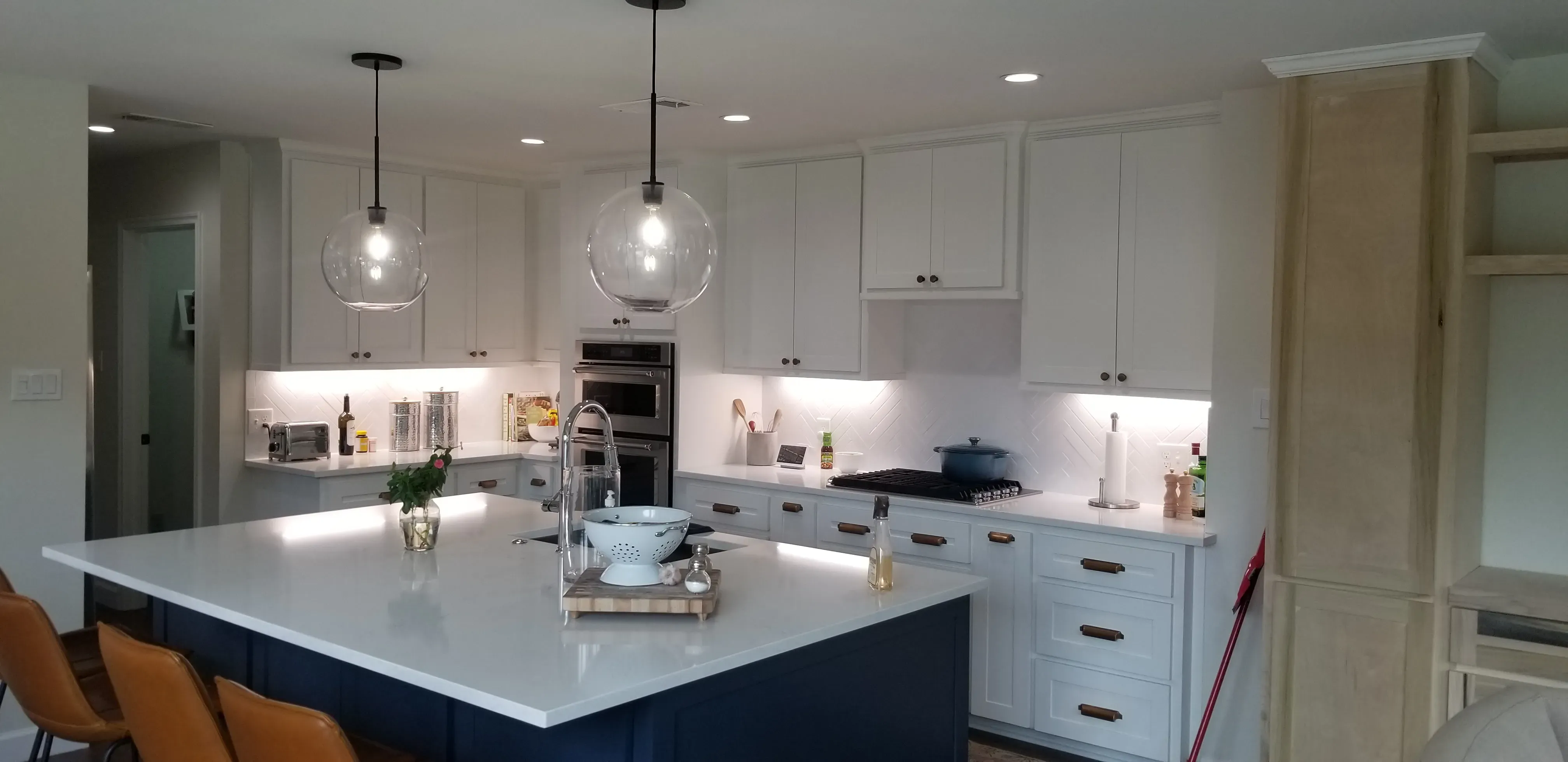 Traditional raised-panel kitchen cabinets with decorative corbels and plate rail